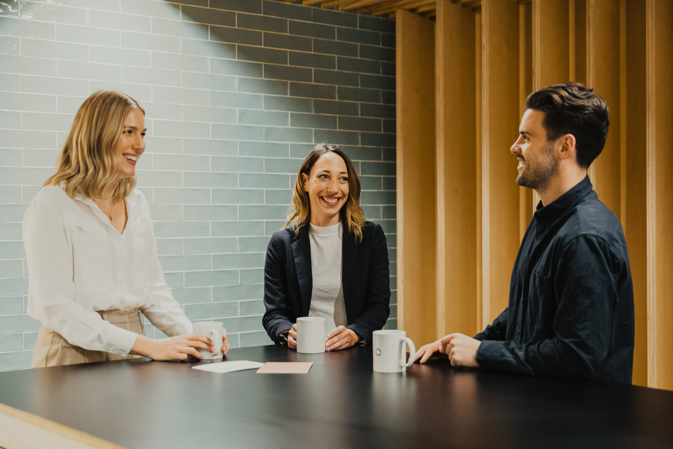 Three people smiling